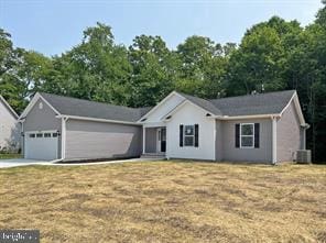 single story home with a front yard and a garage