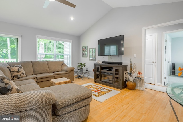 living room featuring ceiling fan, hardwood / wood-style floors, and high vaulted ceiling