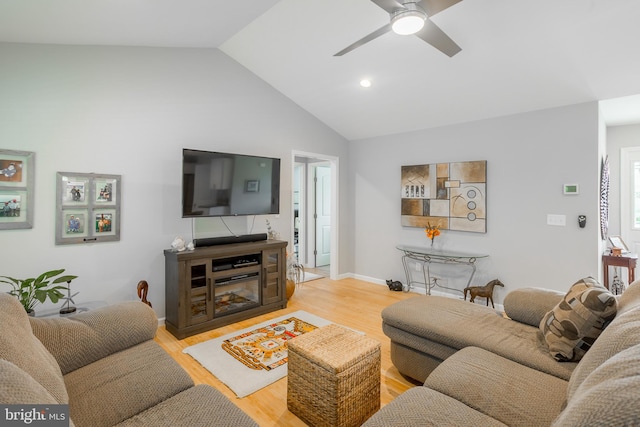 living room with ceiling fan, lofted ceiling, and hardwood / wood-style floors