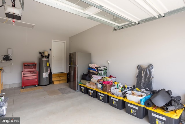 garage with water heater, a garage door opener, and stainless steel refrigerator