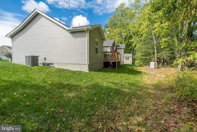 view of property exterior with a wooden deck, a yard, and central air condition unit