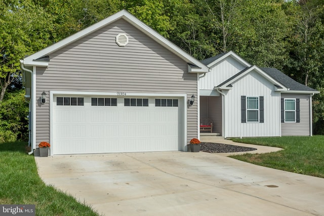 view of front of house with a garage and a front yard