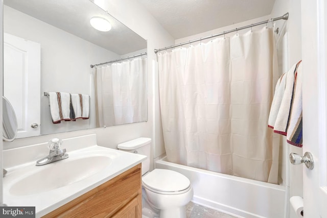 full bathroom featuring vanity, toilet, shower / bathtub combination with curtain, and a textured ceiling