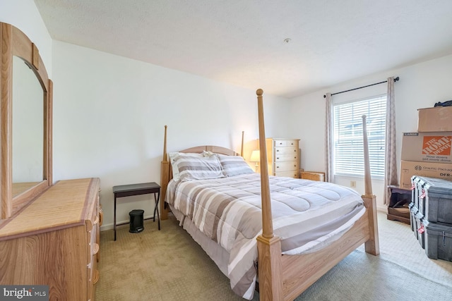 carpeted bedroom featuring a textured ceiling