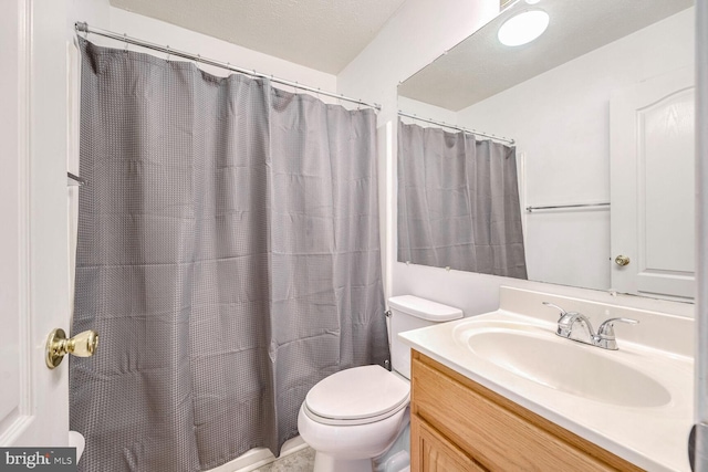 bathroom featuring vanity, toilet, a textured ceiling, and a shower with curtain