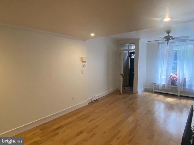 unfurnished room with ornamental molding, ceiling fan, and light hardwood / wood-style flooring