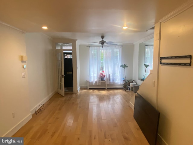 entryway featuring ceiling fan, light hardwood / wood-style flooring, and crown molding