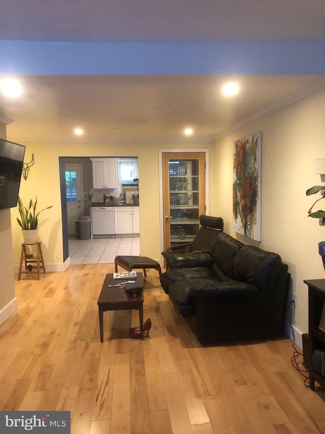 living room featuring light hardwood / wood-style floors and ornamental molding