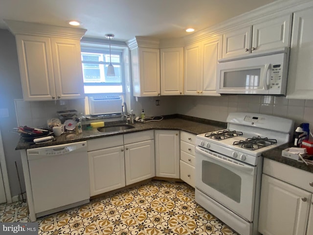 kitchen featuring white cabinets, tasteful backsplash, and white appliances