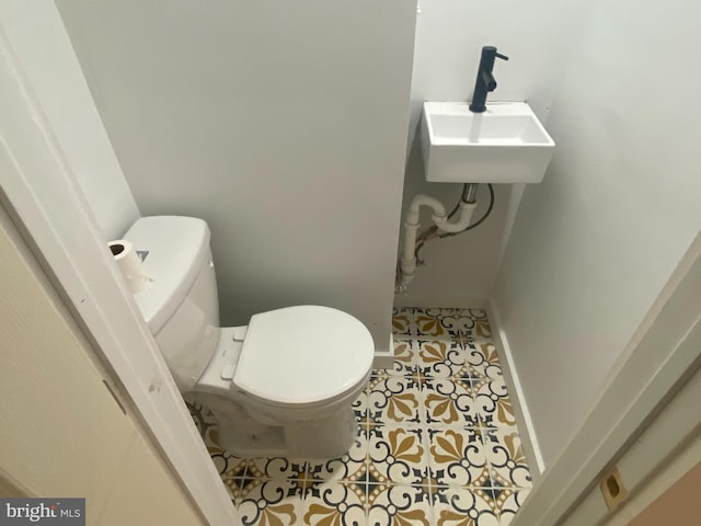 bathroom with tile patterned flooring, toilet, and sink