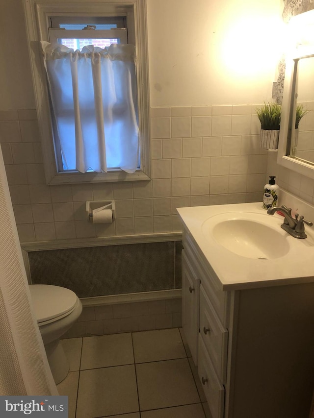 bathroom with tile walls, tile patterned flooring, vanity, and toilet