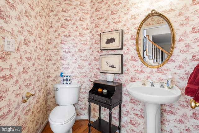 bathroom featuring hardwood / wood-style flooring and toilet