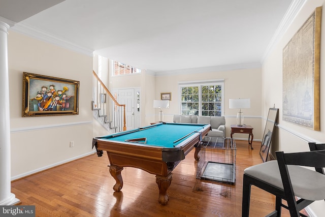 recreation room with ornamental molding, decorative columns, and light hardwood / wood-style floors