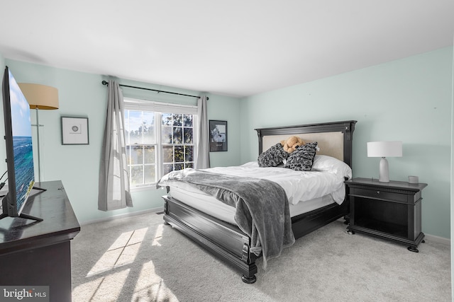 bedroom featuring light carpet