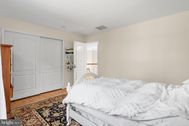 bedroom with hardwood / wood-style flooring and a closet