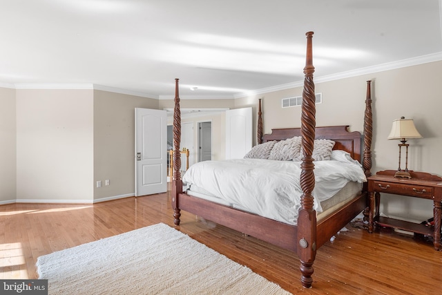 bedroom featuring wood-type flooring and crown molding