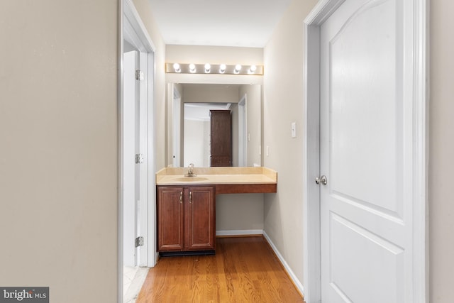 bathroom with vanity and hardwood / wood-style floors