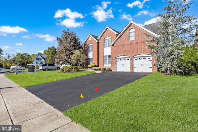 front facade with a front lawn and a garage