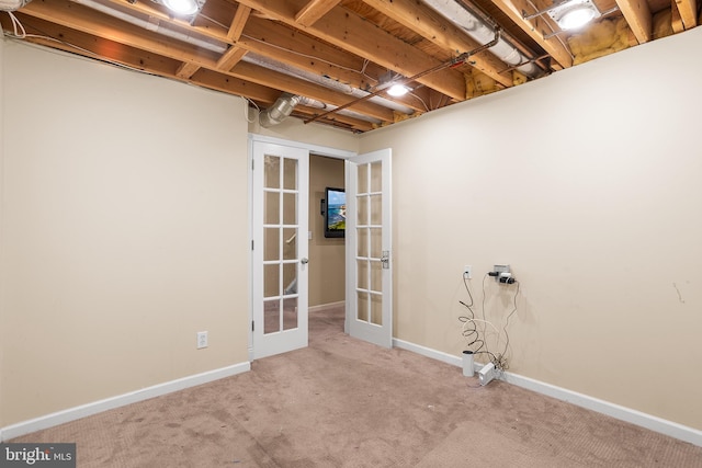 spare room featuring french doors and light carpet