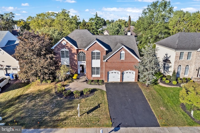 front of property featuring a front lawn and a garage