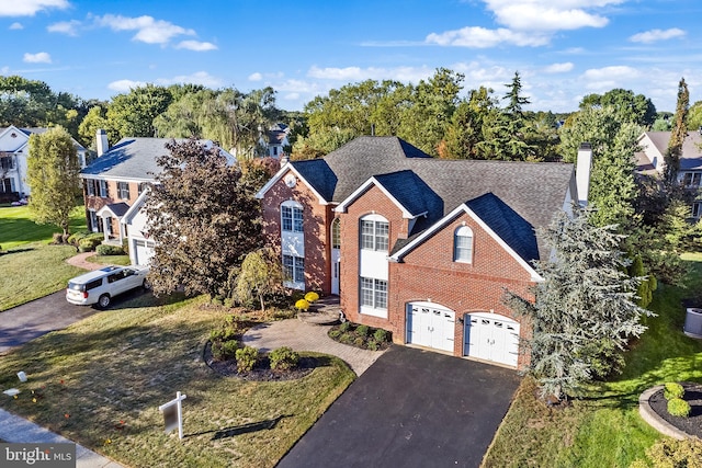 view of front property with a garage and a front yard