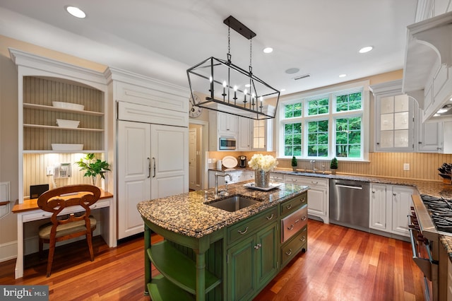 kitchen with sink, wood-type flooring, a kitchen island with sink, white cabinetry, and stainless steel appliances