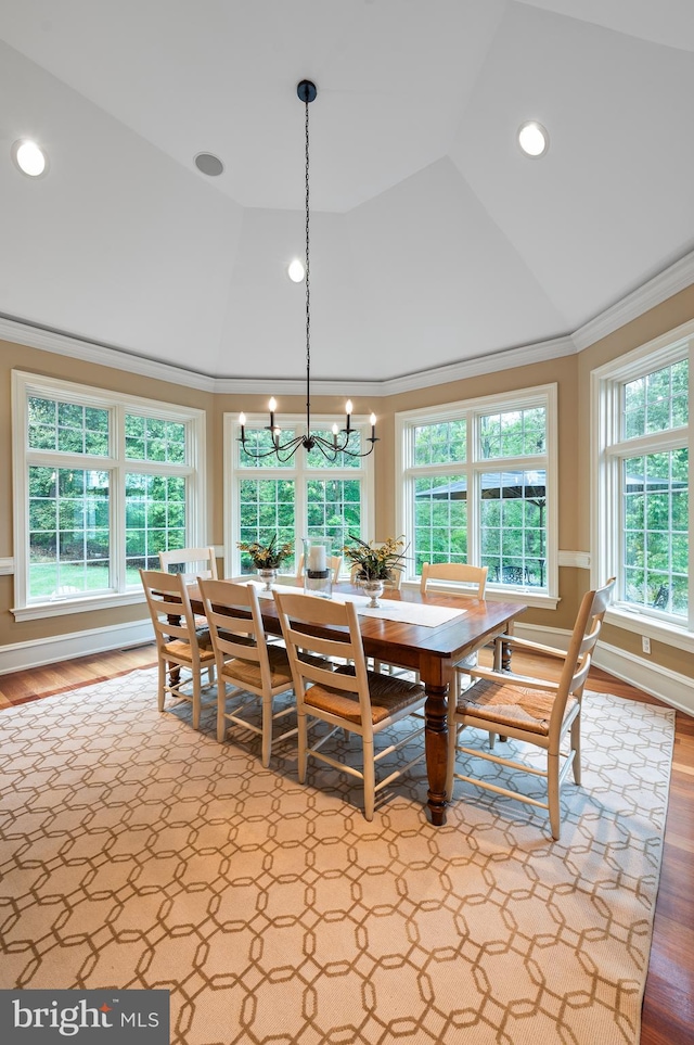 dining area with wood-type flooring, plenty of natural light, and ornamental molding