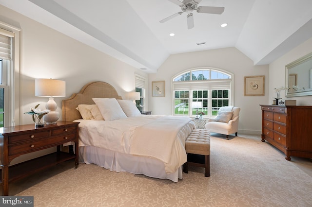 bedroom with ceiling fan, light carpet, and vaulted ceiling