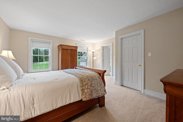 bedroom featuring light colored carpet