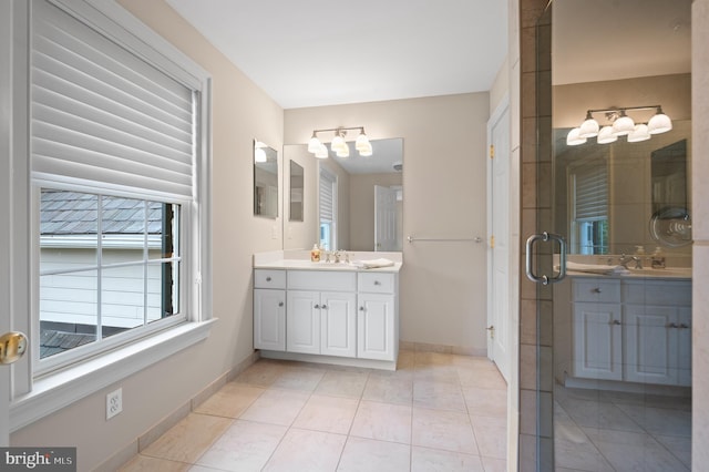 bathroom with tile patterned floors, vanity, and a shower with shower door