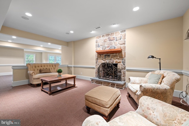 living room featuring a fireplace and carpet