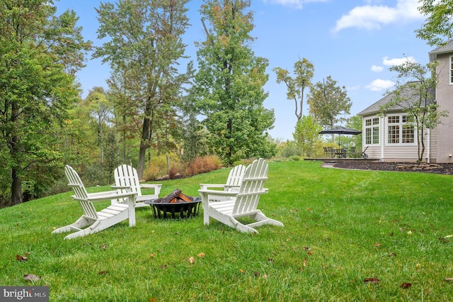 view of yard featuring an outdoor fire pit and a patio area