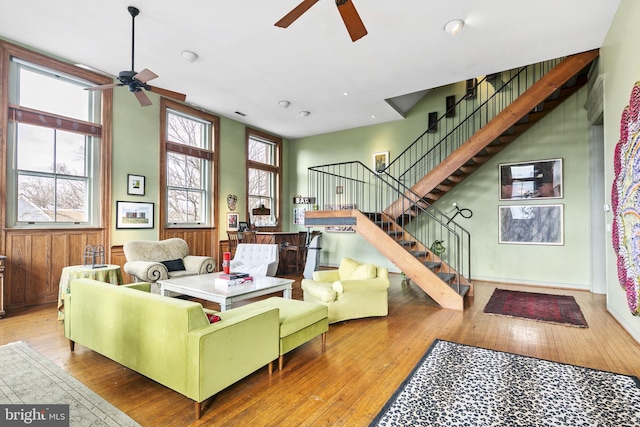 living room with light wood-type flooring and ceiling fan