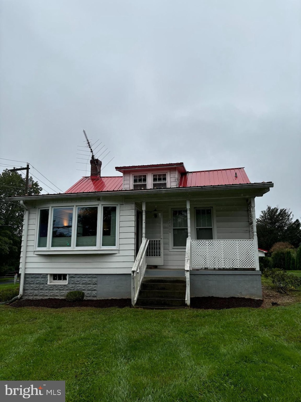 bungalow-style house with covered porch and a front yard