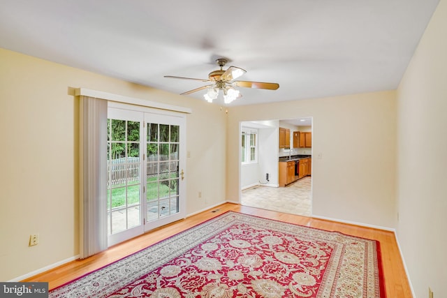 spare room featuring ceiling fan and light hardwood / wood-style floors