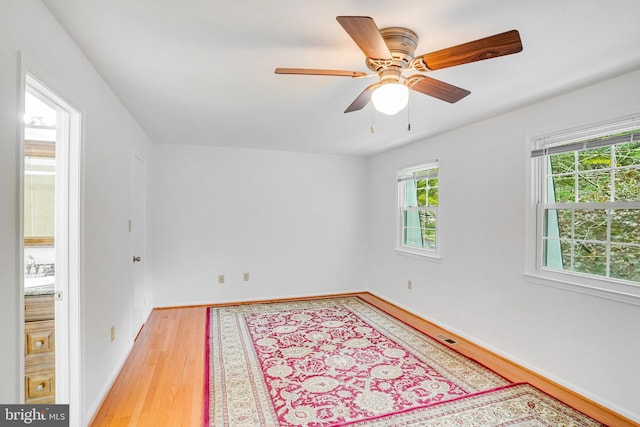 unfurnished room with ceiling fan and light hardwood / wood-style floors