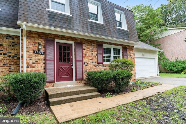 view of exterior entry with a garage