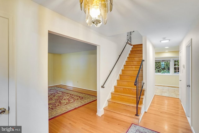 entryway with a notable chandelier and hardwood / wood-style floors