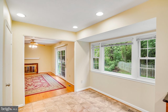 interior space featuring light hardwood / wood-style floors and ceiling fan