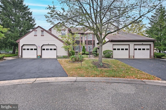 traditional-style house featuring a garage and driveway