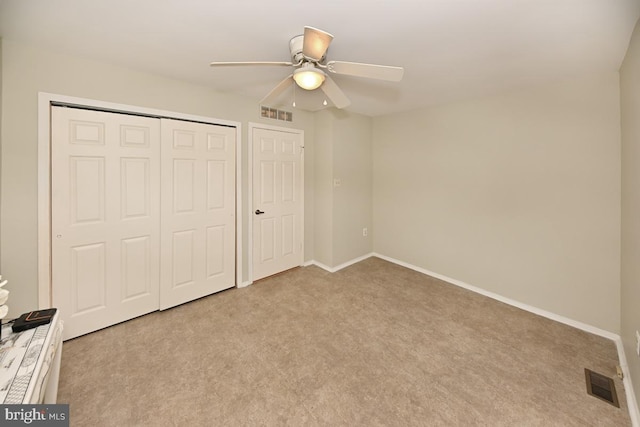 unfurnished bedroom with baseboards, visible vents, and a closet