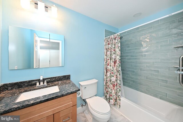 bathroom featuring toilet, vanity, baseboards, marble finish floor, and shower / bath combo