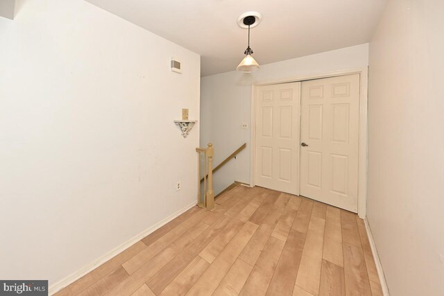 interior space with light wood-style floors and baseboards