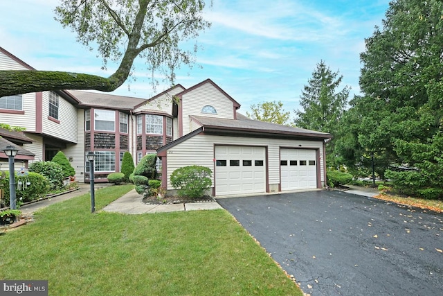 view of front facade featuring aphalt driveway, a front lawn, and a garage