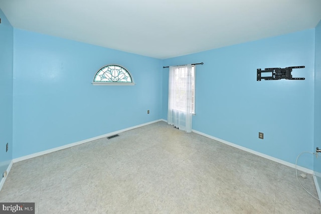 empty room featuring visible vents and baseboards