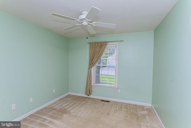 unfurnished room with ceiling fan and light colored carpet