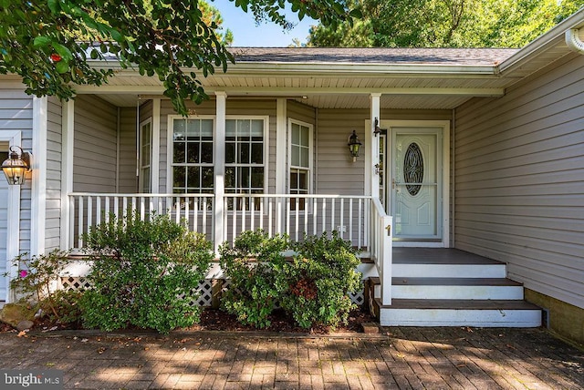 view of exterior entry with covered porch