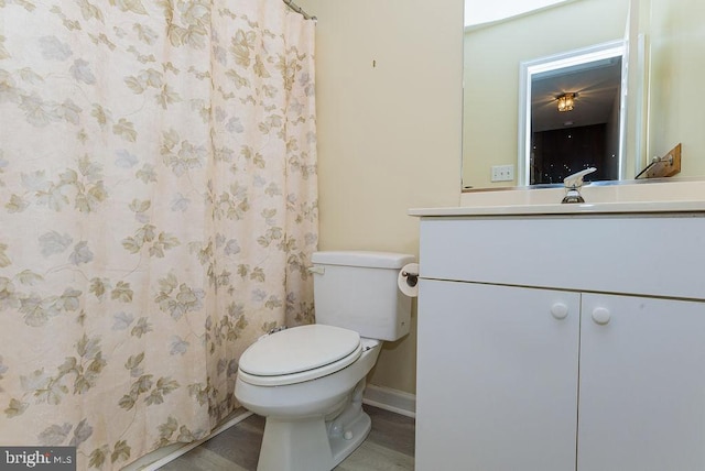 bathroom with a shower with curtain, vanity, toilet, and hardwood / wood-style flooring