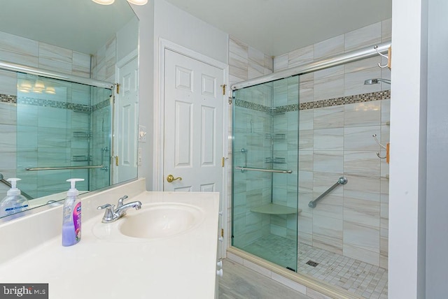 bathroom featuring vanity and a shower with shower door