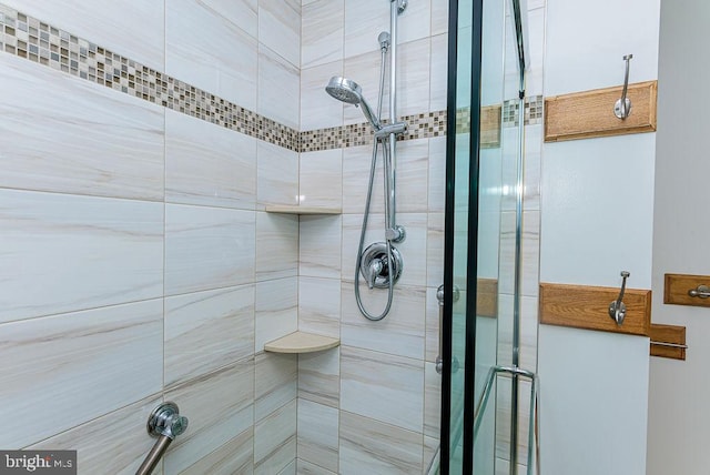 bathroom featuring a shower with shower door